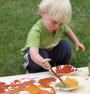 Child painting with natural non toxic paints